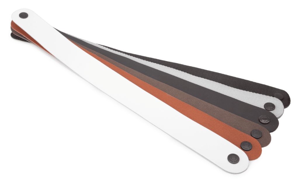 Straps for a hotel luggage rack in different colours and materials
