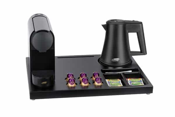 Hospitality tray of black brown wood with Nespresso machine and black kettle