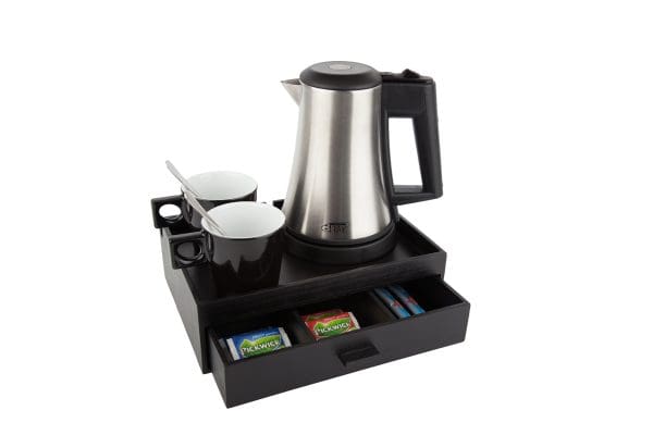 Compact hospitality tray with small stainless steel water kettle and black cappuccino cups