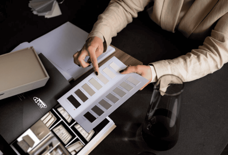 Woman selecting colours and materials for custom hospitality tray for hotel room